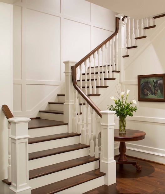 Curved staircase remodel with painted white risers and dark oak treads
